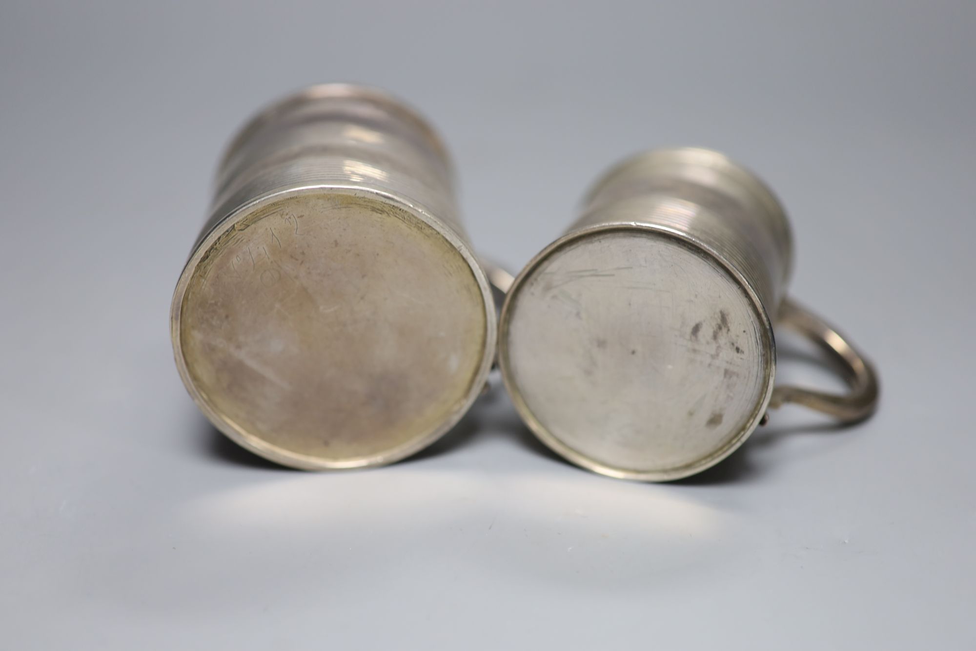 A George III reeded silver christening mug, London, 1812 and one other later mug, London, 1827,